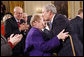 President George W. Bush kisses Arlene Howard on the forehead following his farewell address to the nation Thursday evening, Jan. 15, 2009 in the East Room of the White House. The President met Ms. Howard shortly after Sept. 11, 2001, where she gave him her son's police badge after he perished in the terrorists attacks on the World Trade Center. President Bush still carries the badge with him today as a reminder of all that was lost. White House photo by Eric Draper