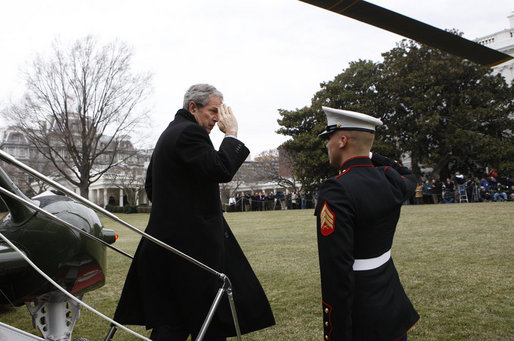 President George W. Bush salutes a U.S. Marine crew member of Marine One upon his return to the White House Sunday, Jan. 18, 2009 from Camp David, which marks President Bush's final return to the South Lawn of the White House aboard the Presidential helicopter as President. White House photo by Chris Greenberg