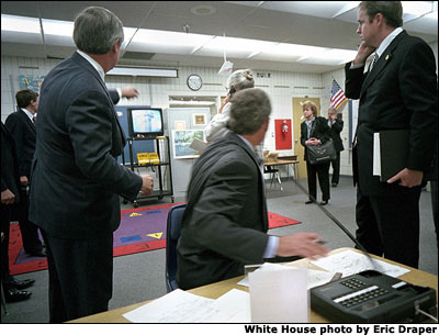 At Emma Booker Elementary School in Sarasota, Fla., President Bush watches video footage of the World Trade Tower attack. White House photo by Eric Draper.