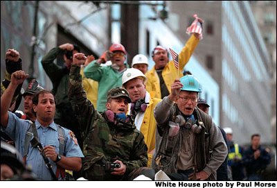 Rallying around President Bush's visit to New York Sept. 14, rescue workers cheer and chant, 