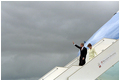 President George W. Bush waves as he and Laura Bush depart Air Force One upon arrival in Paris May 26, 2001.