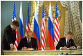 Presidents Bush and Putin sign a historic arms reduction treaty at the Kremlin in Moscow May 24.