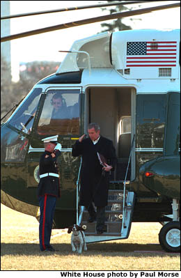 President Bush salutes an officer while Departing Marine One. White House photo by Paul Morse.