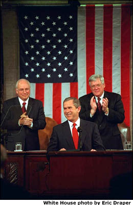 President Bush speaks to Congress. Vice President Cheney and Speaker Hastert stand behind him and applaud. White House photo by Eric Draper.