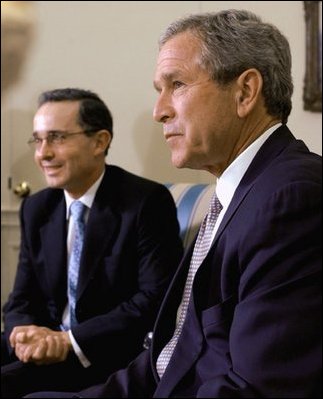 President George W. Bush and President of Colombia Alvaro Uribe take questions from the press in the Oval Office Wednesday, April 30, 2003. 