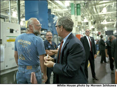 While touring Harley Davidson's Milwaukee factory, President Bush signs an employee's shirt during a visit Aug. 20. White House photo by Moreen Ishikawa.