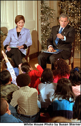 President George W. Bush and Mrs. Bush read to a group of children during the White House Christmas Story Hour Dec. 10. White House photo by Susan Sterner.