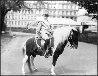 Archie Roosevelt poses with Algonquin the calico pony, June 17, 1902. Algonquin once rode in the White House elevator to visit Archie when he was ill.