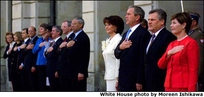 President George W. Bush, Laura Bush, and the American delegation listen to the playing the American national anthem with President Aleksander Kwasniewski of Poland and Mrs. Kwasniewski during an arrival ceremony at the Polish Presidential Palace. White House photo by Moreen Ishikawa