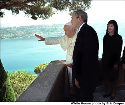 President Bush and Mrs. Bush visit His Holiness Pope John Paul II at Castel Gondolfo in Rome July 23. After posing for pictures, the two leaders took a short walk together and talked privately. White House photo by Eric Draper.