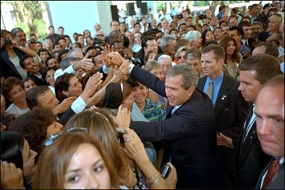 President George W. Bush greets enthusiastic crowds in Lima, Peru, Saturday, March 23, 2002. During his historic visit, President Bush announced specific programs to bring Americans and Peruvians together, such as sending the Peace Corps to the region. White House photo by Eric Draper