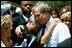 President George W. Bush hugs a woman attending the Annual Peace Officers' Memorial Service at the U.S. Capitol in Washington, D.C., Saturday, May 15, 2004. "I also thank all the family members who have come to Washington for this service. For each of you, there is a name on the National Law Enforcement Officers Memorial that will always stand apart. You feel the hurt of loss and separation, but I hope that you don't feel alone," said the President. 