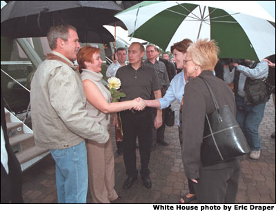 Laura Bush, right, greets Russian First Lady Lyudmila Putin with President George W. Bush and Russian President Vladimir Putin during their arrival at the Bush Ranch in Crawford, Texas, Wednesday, Nov. 14, 2001. White House photo by Eric Draper.