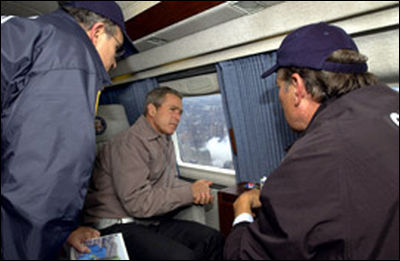 Flying over the Pentagon on his way to New York, President George W. Bush surveys the damage of one site while preparing to visit another Sept. 14.