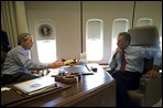 En route to Michigan, President Bush and President Kwasniewski talk on Air Force One. In addition to a private meeting in the President Bush's office, the Polish head of state was treated to a personally-guided tour the famous plane July 18. White House photo by Eric Draper.