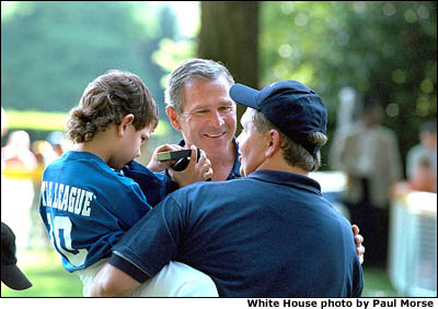 Greeting the players and coaches, President Bush makes new friends while hosting the third tee-ball game at his home. White House photo by Paul Morse.