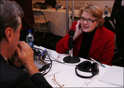 U.S. Department of Education Secretary Margaret Spellings holds an audio earpiece to her ear as she takes questions during the White House Radio Day event Tuesday, Oct. 24, 2006 in Washington, D.C.