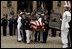 The casket of former President Ronald Reagan is loaded into a hearse at the funeral service at the National Cathedral in Washington, DC on June 11, 2004. 