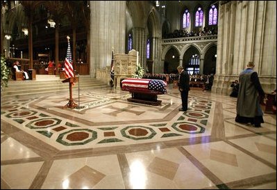 President George W. Bush bows at the casket of former President Ronald Reagan after giving an eulogy at the funeral service for President Ronald Reagan at the National Cathedral in Washington, DC on June 11, 2004. 