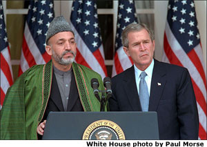 President George W. Bush listens to Chairman of the Afghan Interim Authority Hamid Karzai during their joint press conference in the Rose Garden, January 28. White House photo by Paul Morse.