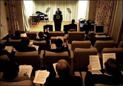 Advisers listen to President Bush’s delivery of his speech in the family theater of the White House Jan. 24, 2003. 
