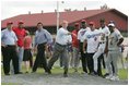 Under the watchful eyes of New York Yankee's Mariano Rivera, second from left, and Panama President Martin Torrijos, third from left, President George W. Bush releases a pitch Monday, Nov. 7, 2005, during a visit with Panamanian youth at Ciudad Del Saber in Panama City, Panama. 