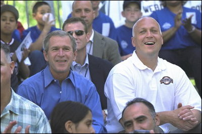 President George W. Bush and Commissioner Cal Ripken watch the game with team families Sunday, May 5, 2002. In addition to moms and dads, Arizona Diamondback Erubiel Durazo, and Major League Baseball Hall of Famers Tony Perez and Orlando Cepeda came to root for the two teams.