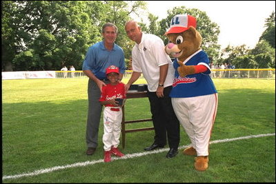 President George W. Bush attends a Tee Ball on the South Lawn with Cal Ripken, game between the Cardinals and the South Berkeley Little League Braves from Inwood, West Virginia. June 23, 2002.