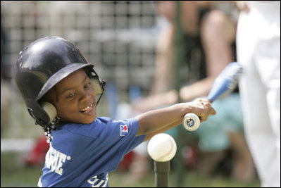 Shaquana Smith of the Jackie Robinson South Ward Little League Black Yankees of Newark, N.J., swings at the ball Sunday, June 26, 2005, during "Tee Ball on the South Lawn."