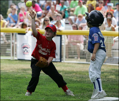 It's safe at first for a Cumberland Bobcat as the Red Wings' first baseman returns the ball to the catcher Wednesday, June 27, 2007, during the first game of the 2007 White House Tee Ball season on the South Lawn. The game pitted the Luray, Virginia team against the Cumberland, Maryland kids, and marked the seventh year of the President's White House Tee Ball Initiative.
