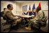 Vice President Dick Cheney speaks with Brigadier General Robert Crear, Commander of the Mississippi Valley Division of the U.S. Army Corps of Engineers, during a briefing on Hurricane Katrina recovery held at the New Orleans Port Authority in New Orleans, La., Thursday, October 12, 2006. The U.S. Army Corps of Engineers has been working to address flood problems along the Mississippi River since the 1800's and is responsible for rebuilding the 169 miles of levees in the southeast Louisiana area that sustained damage as a result of Katrina.