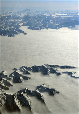 Clouds blanket Alaskan mountain peaks as seen from aboard Air Force Two while en route to Tokyo, Feb. 19, 2007. White House photo by David Bohrer
