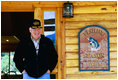 Vice President Dick Cheney stands outside a cabin on the banks of the Snake River during a fishing trip to Idaho.