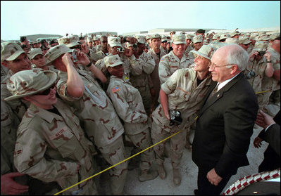 Troops at Al-Udeid Airbase in Qatar gather around Vice President Dick Cheney for pictures and handshakes March 17, 2002.