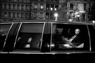 Vice President Dick Cheney receives an early morning intelligence briefing inside his limousine at the White House, Nov. 29, 2001.
