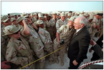 Troops at Al-Udeid Airbase in Qatar gather around Vice President Dick Cheney for pictures and handshakes March 17.