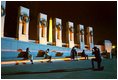 As night falls over the memorial, visitors cool off on the granite benches of the National World War II Memorial the week before its official dedication during Memorial Day Weekend.