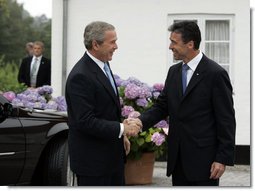 President George W. Bush is greeted by Danish Prime Minister Anders Fogh Rasmussen at his summer residence in Marienborg in Kongens Lyngby, Denmark, Wednesday, July 6, 2005. White House photo by Paul Morse
