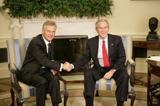 President George W. Bush and Poland's President Aleksander Kwasniewski shake hands as they meet with reporters in the Oval Office at the White House, Wednesday, Oct. 12, 2005 in Washington. White House photo by Eric Draper