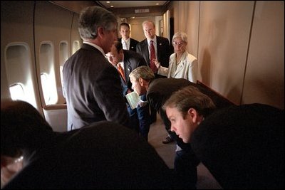 President Bush and his staff look out the windows from Air Force One at their F-16 escort while en route to Barksdale Air Force Base in Louisiana Sept. 11, 2001. 