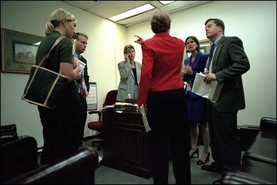White House Counselor Karen Hughes meets with fellow staff members at the State Department shortly before making a statement to the press Sept. 11, 2001. 