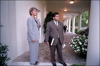 Counselor Karen Hughes and Counsel Alberto Gonzales wait on the colonnade for President George W. Bush to arrive at the White House Sept. 11, 2001. 