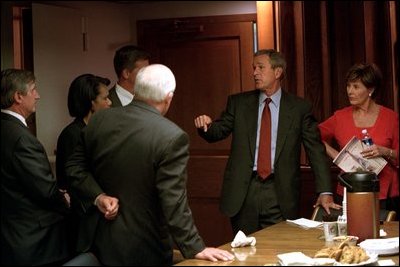 President George W. Bush and Laura Bush listen talk with Vice President Dick Cheney and Dr. Condoleezza Rice September 11, 2001 in the Presidential Emergency Operations Center (PEOC). 