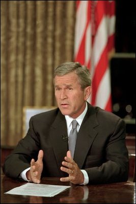 Sitting at his desk in the Oval Office, President George W. Bush addresses the nation on the evening of Sept. 11, 2001. 