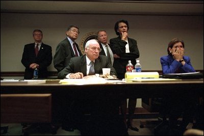As they watch live media coverage of the day's events in the Presidential Emergency Operations Center, Vice President Dick Cheney and senior staff witness the collapse of the South Tower of World Trade Center Sept. 11, 2001. 