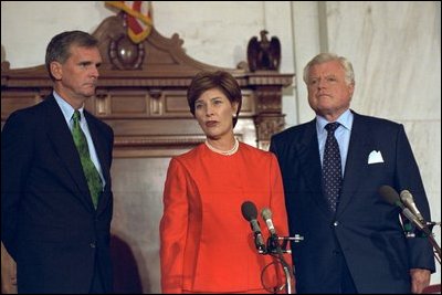 Laura Bush addresses the media in the Senate Russell Office Building Sept. 11, 2001. Standing with Mrs. Bush is Sen. Judd Gregg, left, and Sen. Edward Kennedy. 