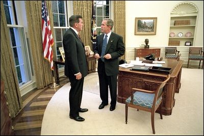 President Bush and Governor Ridge discuss the Office of Homeland Security, Oval Office, Oct. 8, 2001.