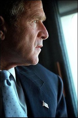 Flying over the Pentagon on his way to New York, President George Bush surveys the damage of one site while preparing to visit another Sept. 14. 
