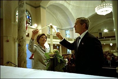 President George W. Bush and Laura Bush light a candle at St. John Episcopal Church in Washington, D.C., during a private service of prayer and remembrance Wednesday morning, September 11, 2002.