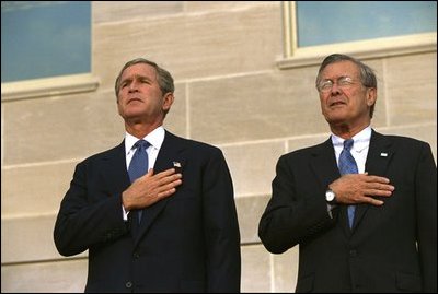 Attending the Pentagon Observance ceremony, President George W. Bush and Secretary of Defense Donald Rumsfeld say the Pledge of Allegiance before speaking Tuesday, Sept. 11, 2002.
